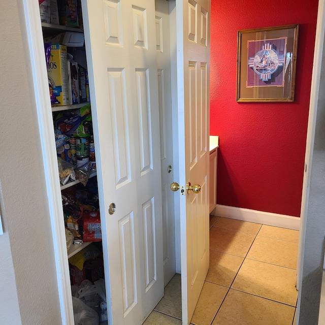 hall featuring light tile patterned floors