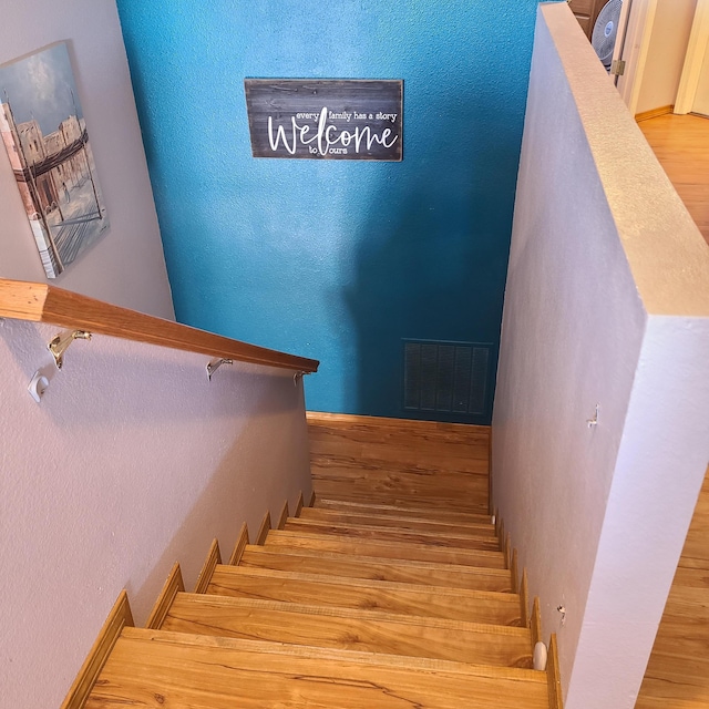 stairway with wood-type flooring