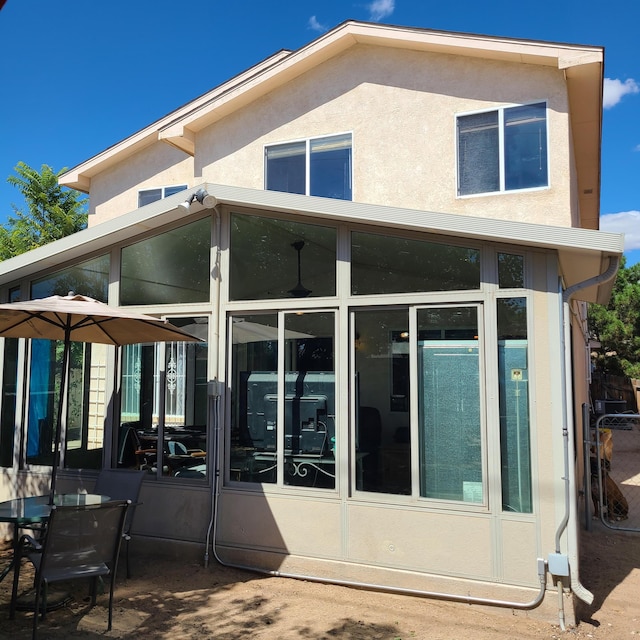 back of house featuring a sunroom