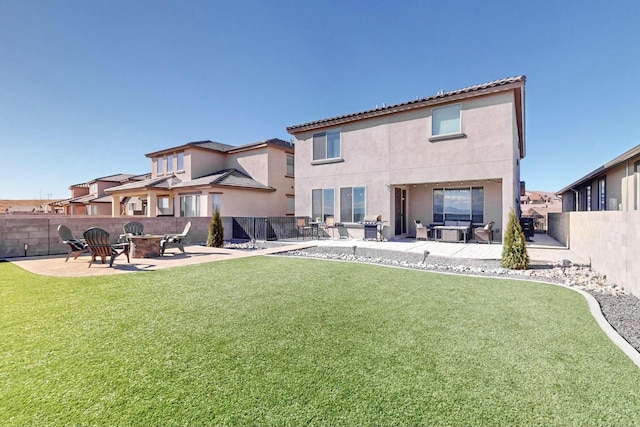 rear view of property featuring a patio and a yard