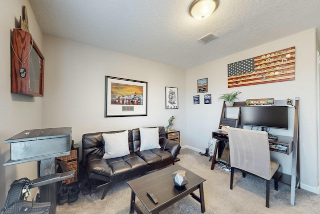 home office featuring a textured ceiling and light colored carpet