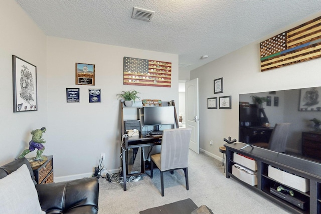 office area featuring a textured ceiling and light carpet