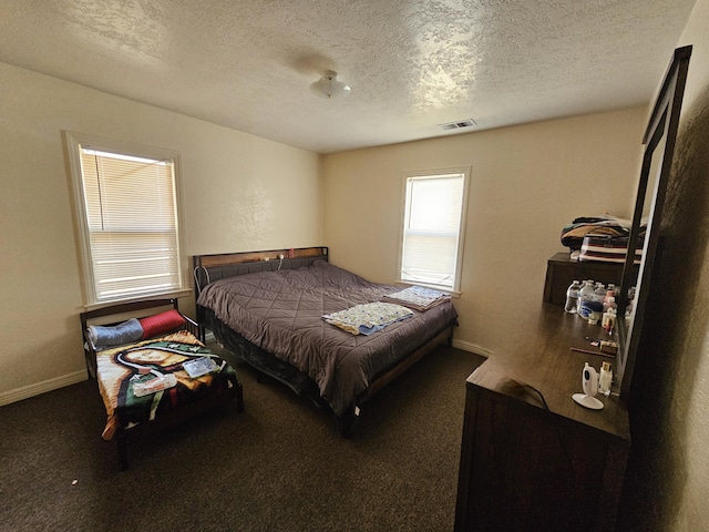 carpeted bedroom with a textured ceiling