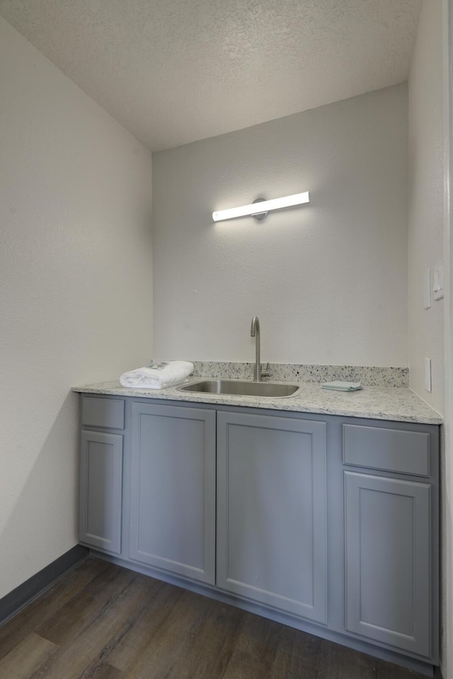 bathroom featuring a textured ceiling, hardwood / wood-style flooring, and vanity