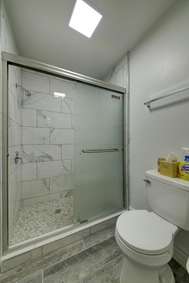 bathroom with toilet and walk in shower