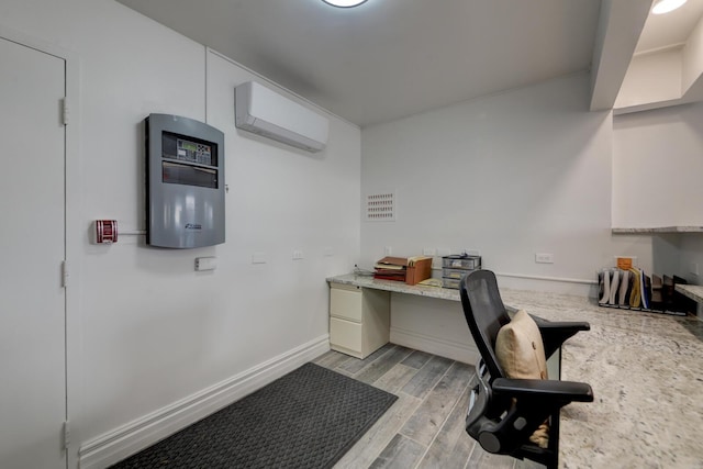 office area with built in desk and a wall mounted AC