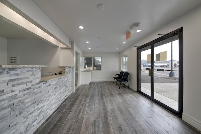 corridor with hardwood / wood-style floors