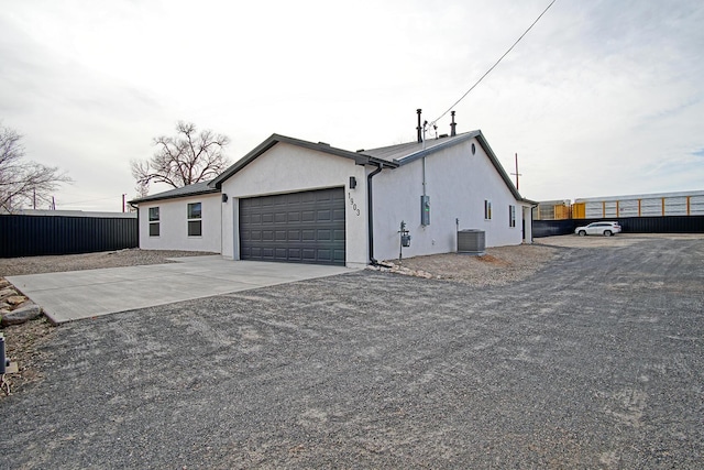 view of property exterior featuring a garage and central AC