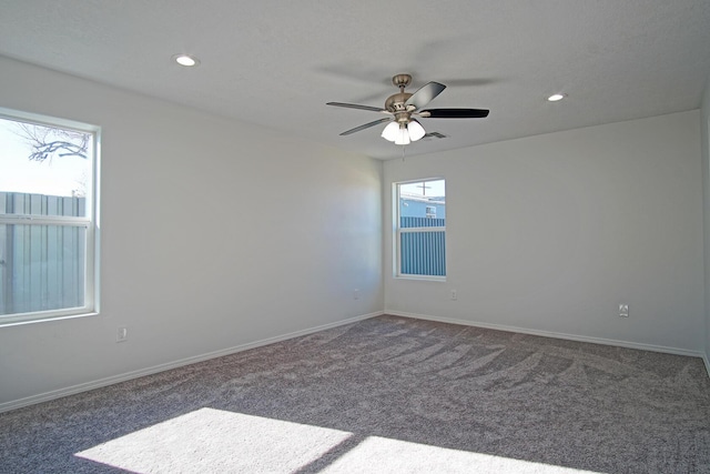 carpeted spare room with ceiling fan