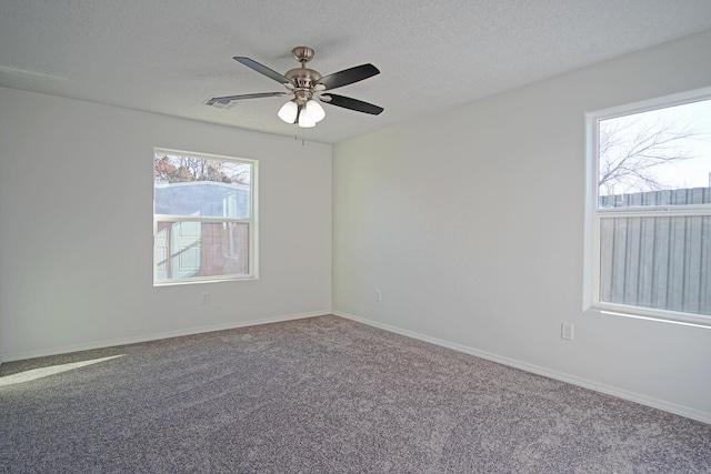 carpeted empty room with a textured ceiling and ceiling fan