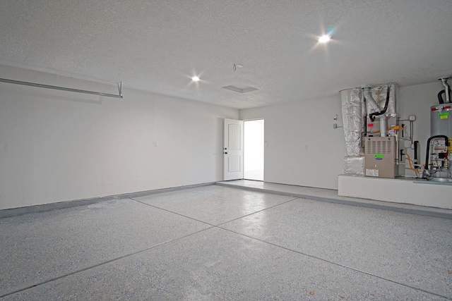 garage featuring water heater and heating unit