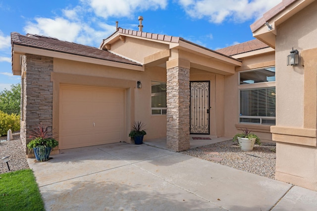 doorway to property with a garage