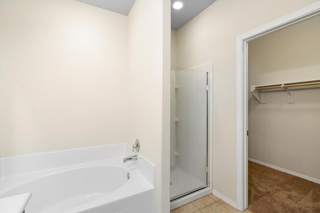 bathroom featuring tile patterned flooring and shower with separate bathtub