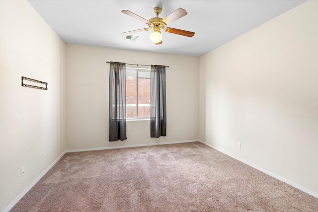 unfurnished room featuring ceiling fan and light colored carpet