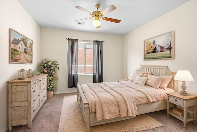 bedroom with ceiling fan and light colored carpet