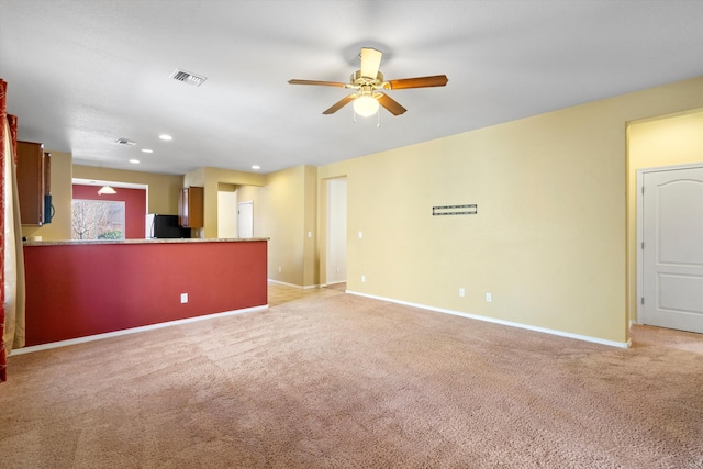 unfurnished living room with light carpet and ceiling fan