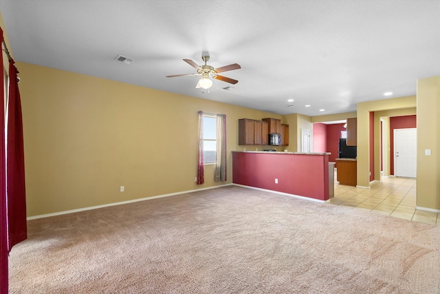 unfurnished living room with light carpet and ceiling fan