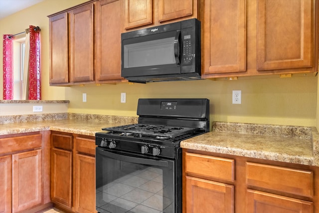 kitchen featuring black appliances and tile patterned flooring