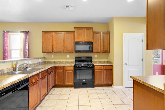 kitchen featuring sink, black appliances, and light tile patterned floors