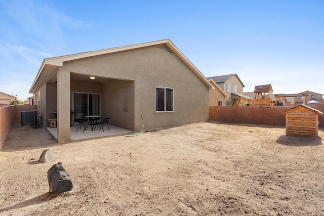 back of property featuring cooling unit and a patio