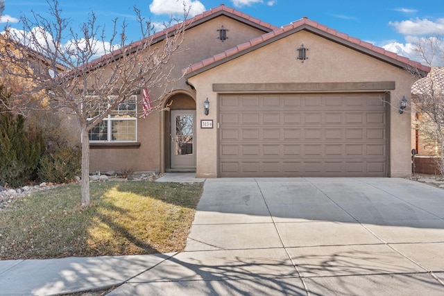 mediterranean / spanish-style home with a garage and a front yard