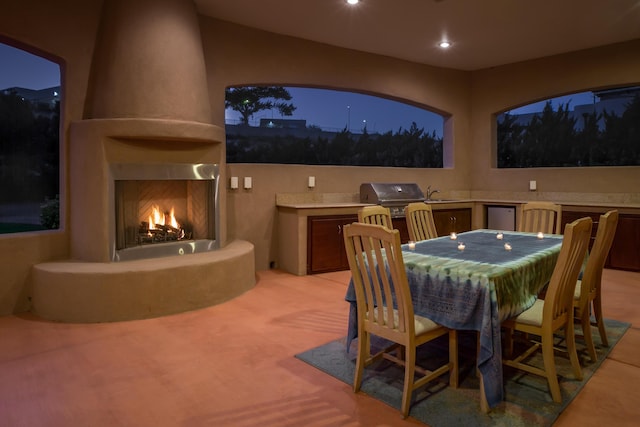 view of patio featuring sink, a large fireplace, and area for grilling