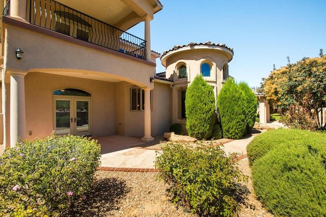 exterior space featuring french doors, a patio area, and a balcony