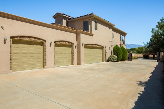 view of side of property featuring a mountain view and a garage