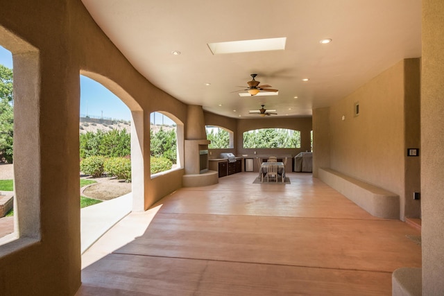 exterior space with ceiling fan and an outdoor kitchen