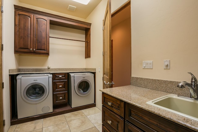 laundry area featuring washer and dryer, sink, cabinets, and light tile patterned flooring