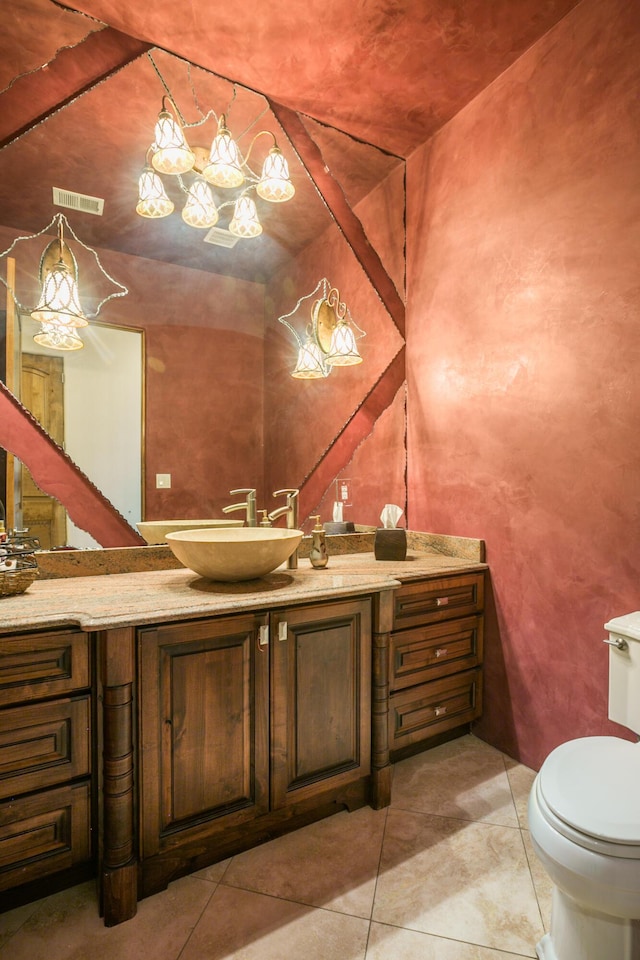 bathroom featuring toilet, tile patterned flooring, and vanity