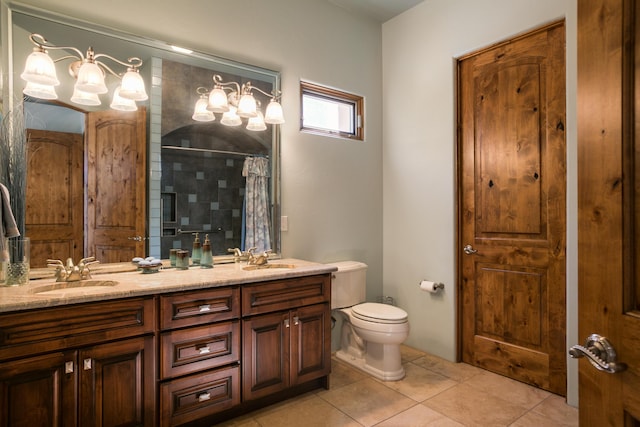 bathroom with toilet, tile patterned flooring, vanity, and curtained shower