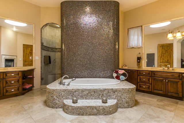 bathroom featuring vanity and separate shower and tub