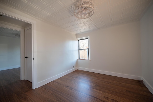 spare room with dark wood-type flooring