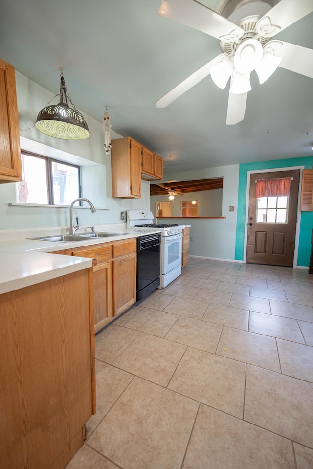 kitchen with a wealth of natural light, white gas stove, dishwashing machine, and decorative light fixtures