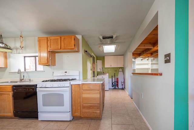 kitchen with washer / dryer, black dishwasher, white gas stove, hanging light fixtures, and sink