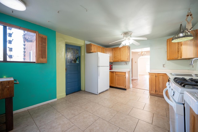 kitchen featuring ceiling fan, sink, white appliances, hanging light fixtures, and light tile patterned floors