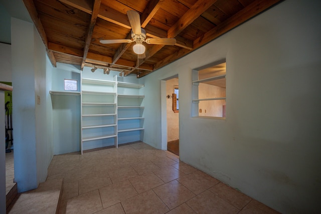 tiled empty room featuring wooden ceiling, track lighting, and ceiling fan