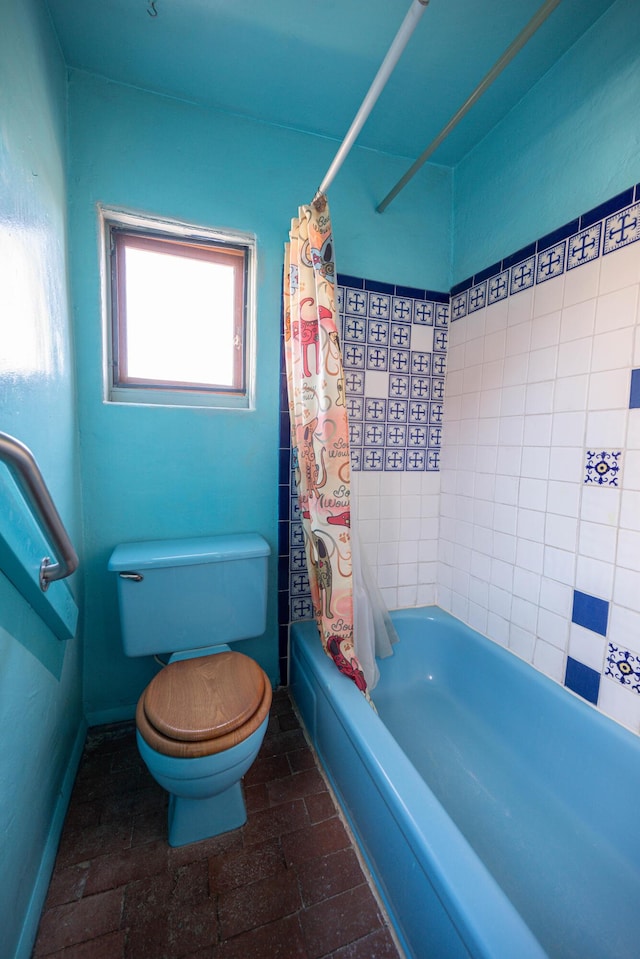 bathroom with toilet and shower / bath combo