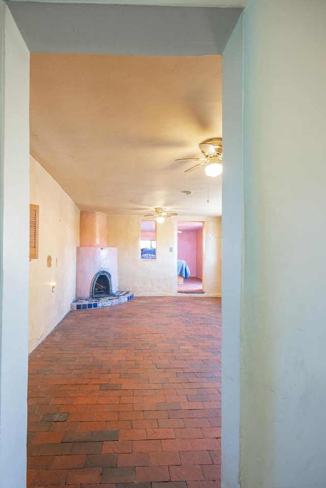 unfurnished living room featuring ceiling fan