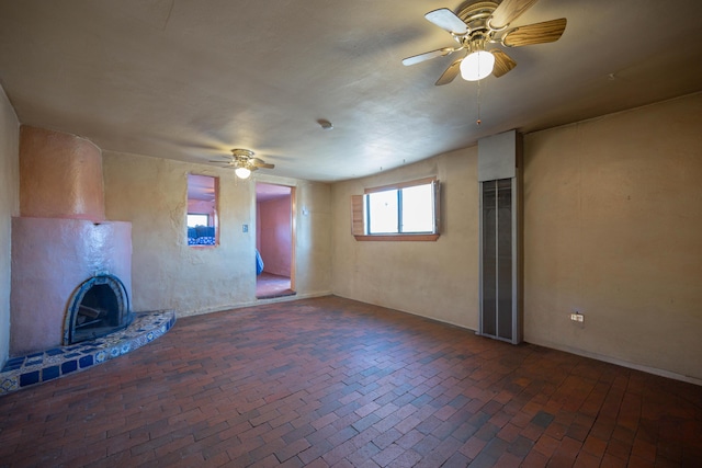 unfurnished living room featuring ceiling fan