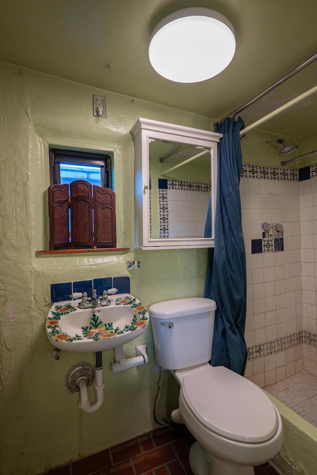 bathroom featuring toilet, walk in shower, and sink