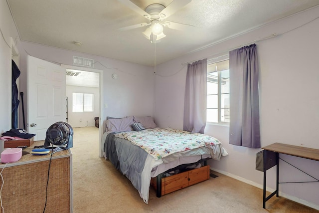 bedroom with light colored carpet and ceiling fan