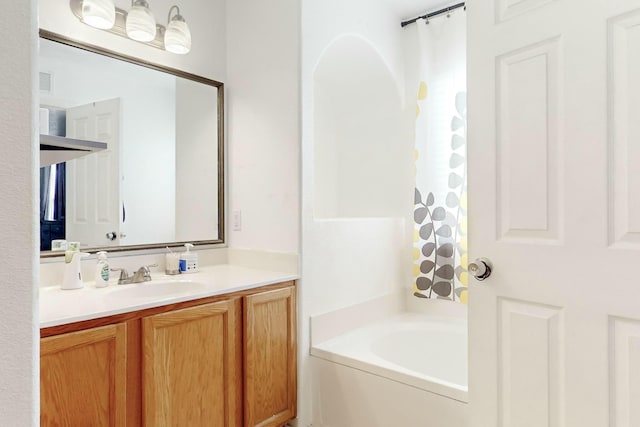 bathroom with vanity and a bathtub