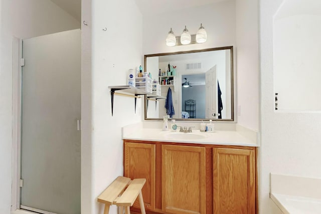 bathroom featuring vanity and a shower with shower door