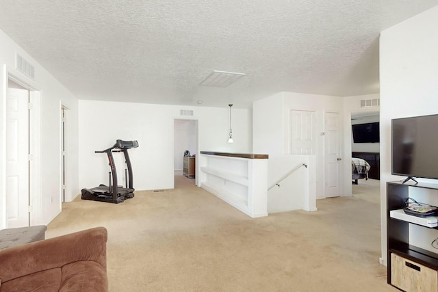 interior space featuring light carpet and a textured ceiling