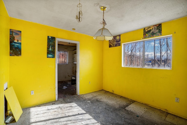 unfurnished room featuring a textured ceiling