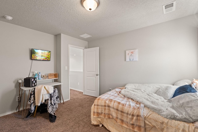 carpeted bedroom with a textured ceiling