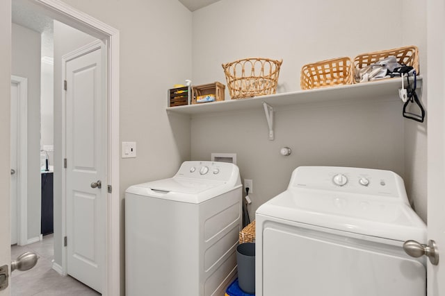 laundry room with light tile patterned flooring and separate washer and dryer