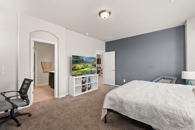 carpeted bedroom featuring a textured ceiling